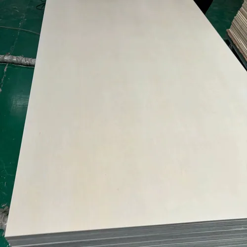 A pale smooth wood-faced plywood sheet above a stack of darker layered panel edges.